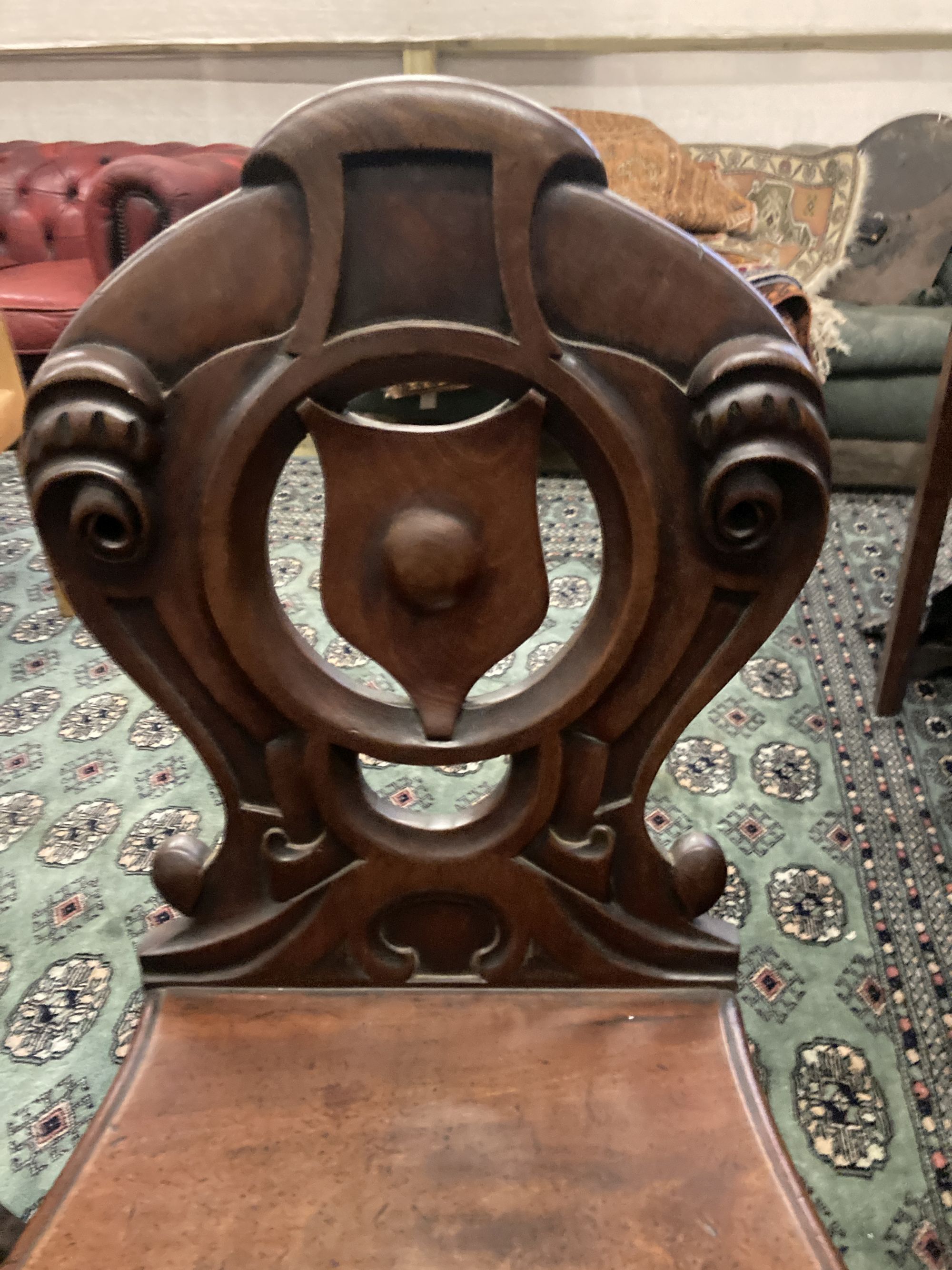 A pair of Victorian mahogany hall chairs